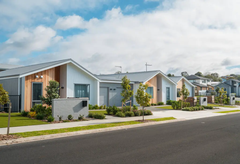 Modern suburban houses with landscaped gardens.