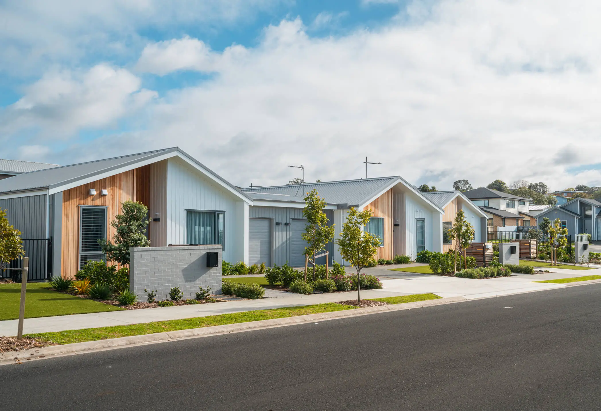 Modern suburban houses with landscaped gardens.